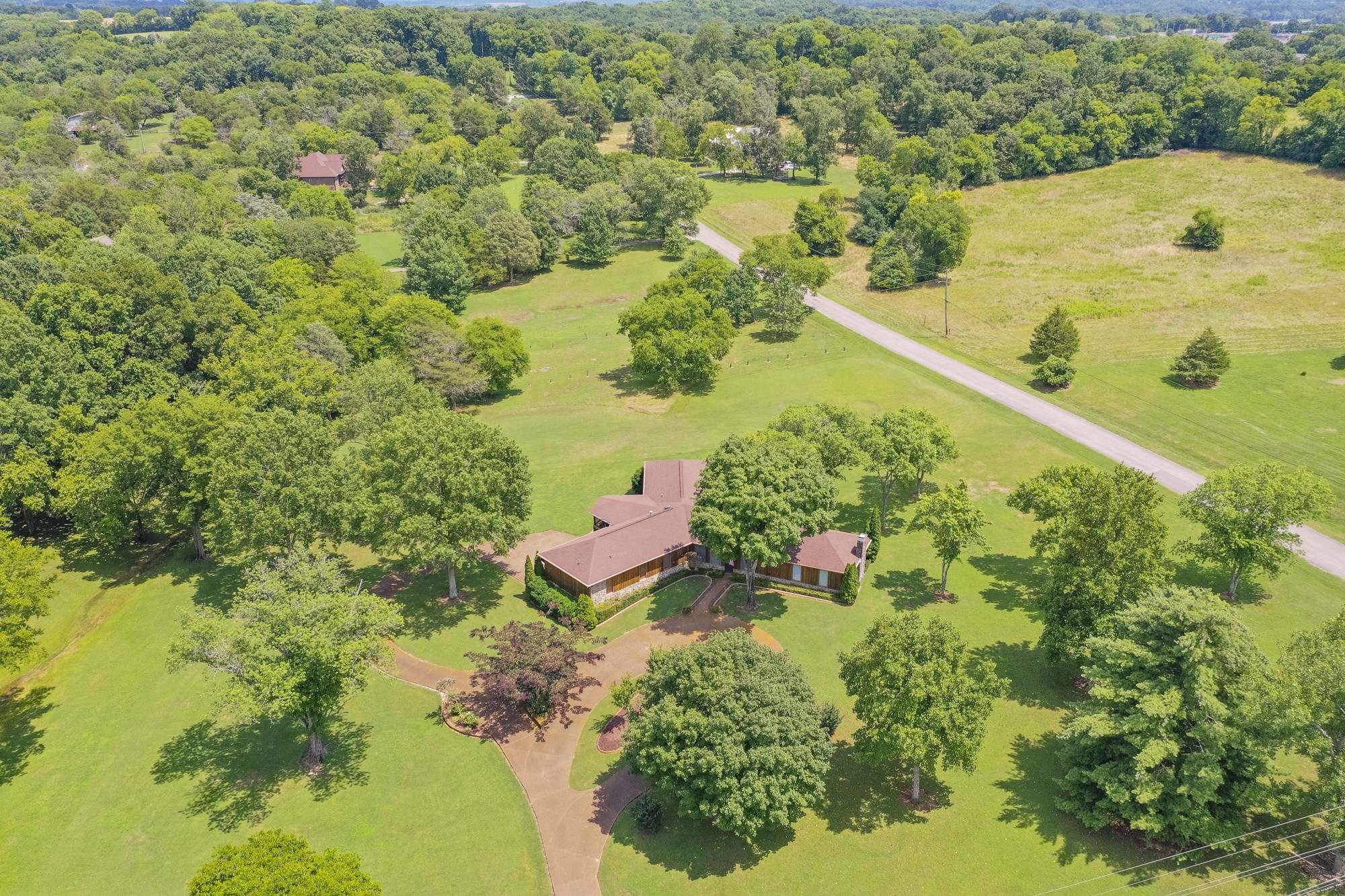 1249 Lock 4 Road Gallatin, TN 37066 - Photo 46 of 49 an aerial view of residential houses with outdoor space and trees all around