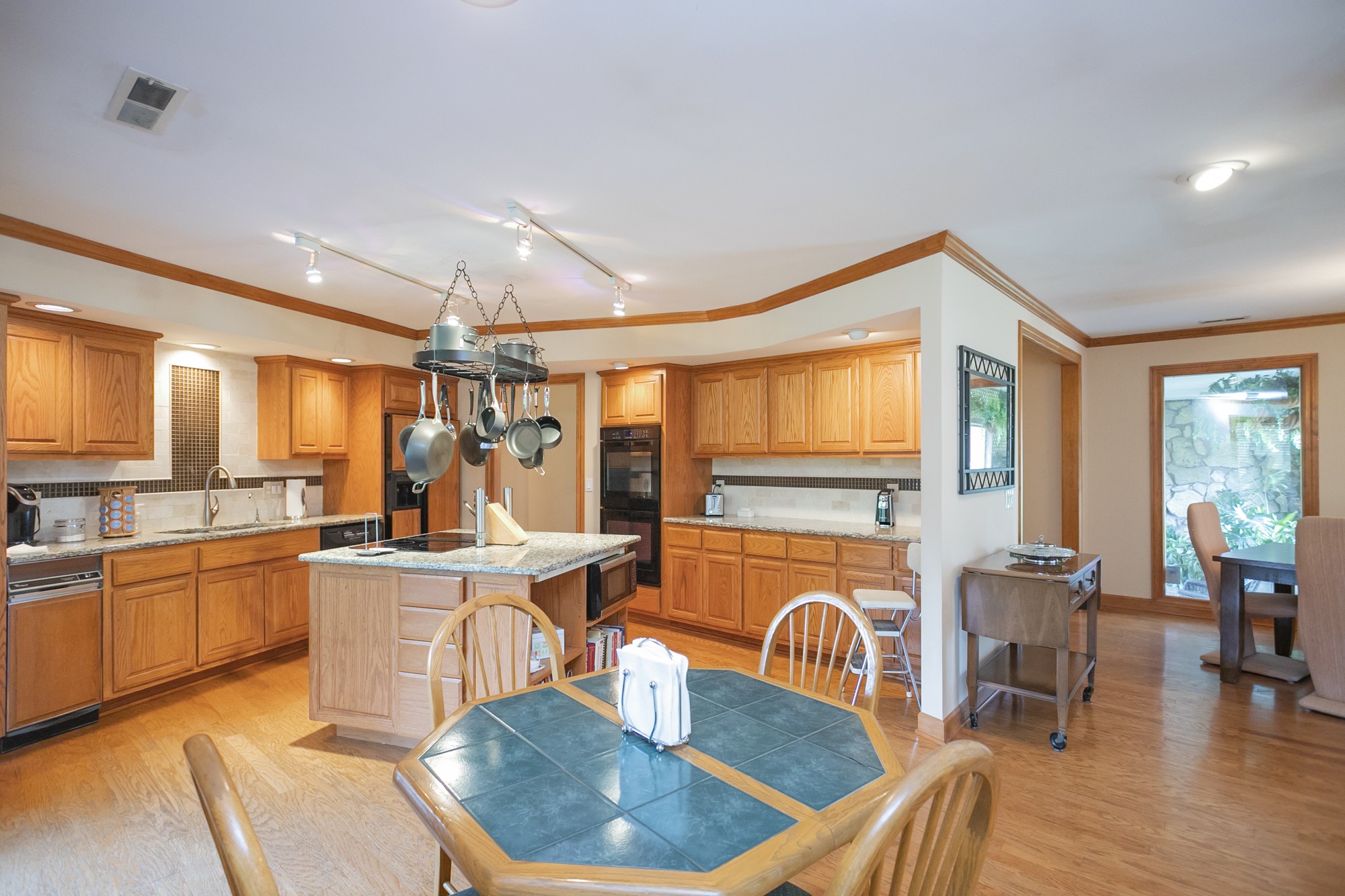 1249 Lock 4 Road Gallatin, TN 37066 - Photo 7 of 49 a kitchen with stainless steel appliances granite countertop a stove a sink a refrigerator dining table and chairs