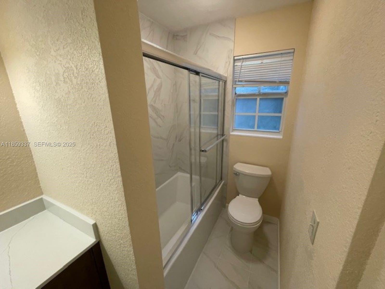 4831 Northwest 12th Street Lauderhill, FL 33313 - Photo 11 of 19 a bathroom with a toilet and a shower