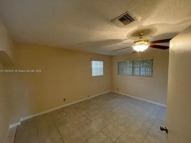 an empty room with a empty space and windows