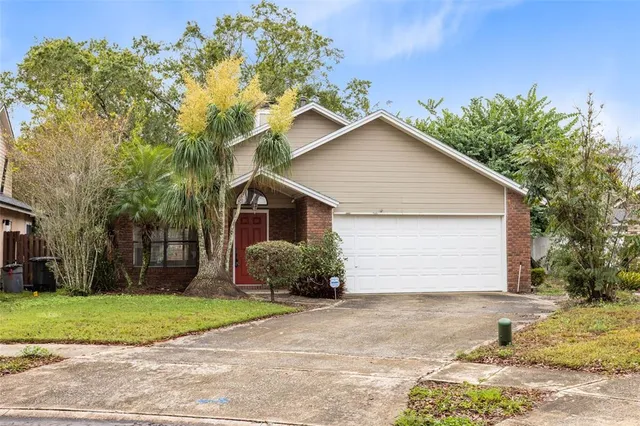 a front view of house with yard and trees around
