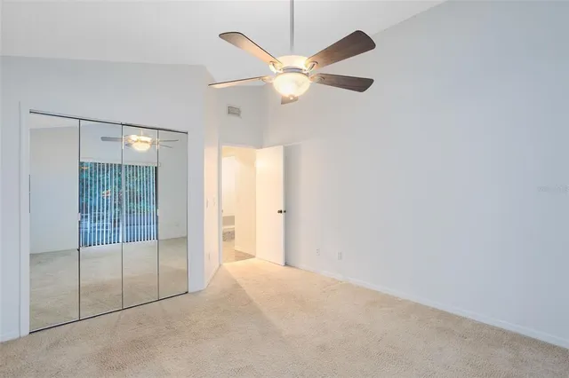 a view of a livingroom with a ceiling fan and window