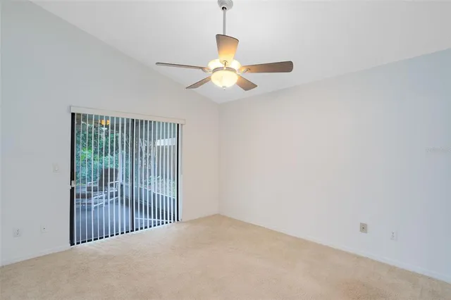 a view of a chandelier fan and window in a room