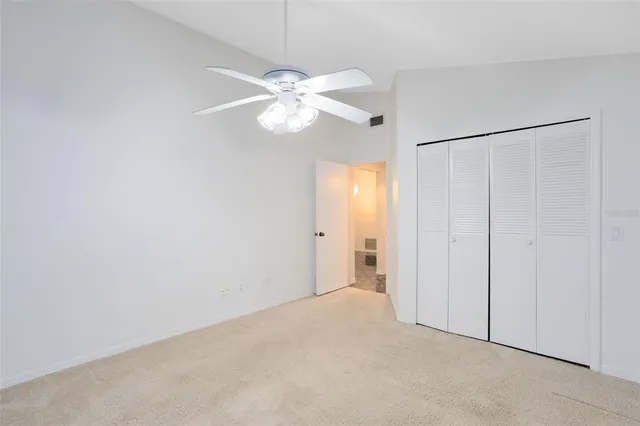 an empty room with a fan and a fan