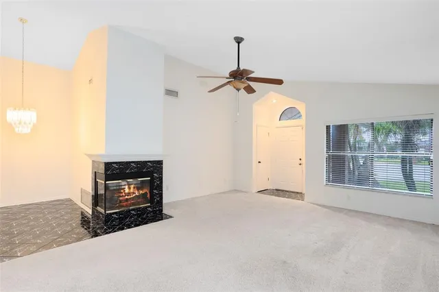 a view of empty room with a fireplace
