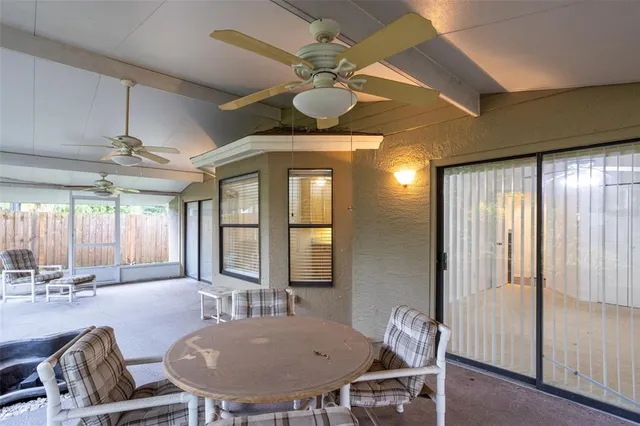 a view of a livingroom with furniture and a ceiling fan