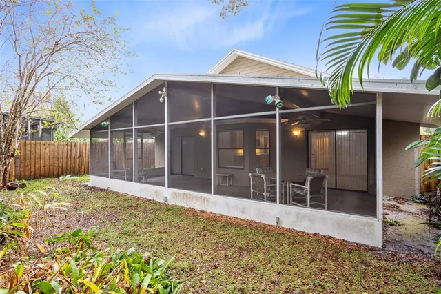 a backyard of a house with plants and wooden fence