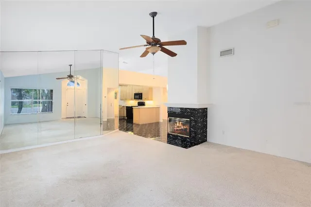 a view of a livingroom with a furniture and chandelier fan