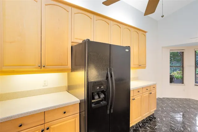 a kitchen with a refrigerator and cabinets