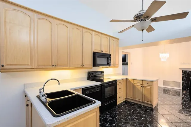 a kitchen with granite countertop a stove sink and cabinets