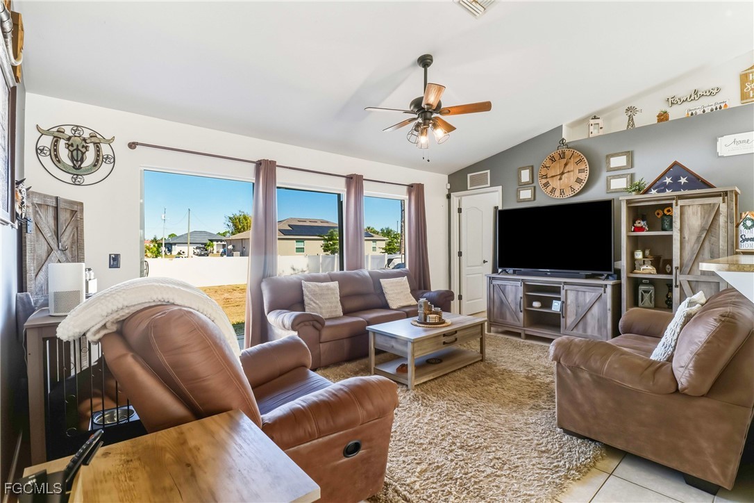 3910 23rd Street Southwest Lehigh Acres, FL 33976 - Photo 11 of 29 a living room with furniture and a flat screen tv