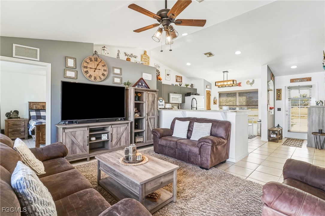 3910 23rd Street Southwest Lehigh Acres, FL 33976 - Photo 14 of 29 a living room with furniture and a flat screen tv