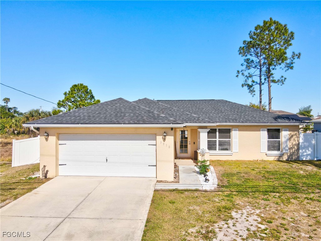3910 23rd Street Southwest Lehigh Acres, FL 33976 - Photo 2 of 29 a house view with a garden space