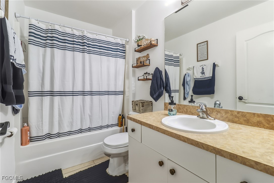 3910 23rd Street Southwest Lehigh Acres, FL 33976 - Photo 23 of 29 a bathroom with a sink a toilet and shower