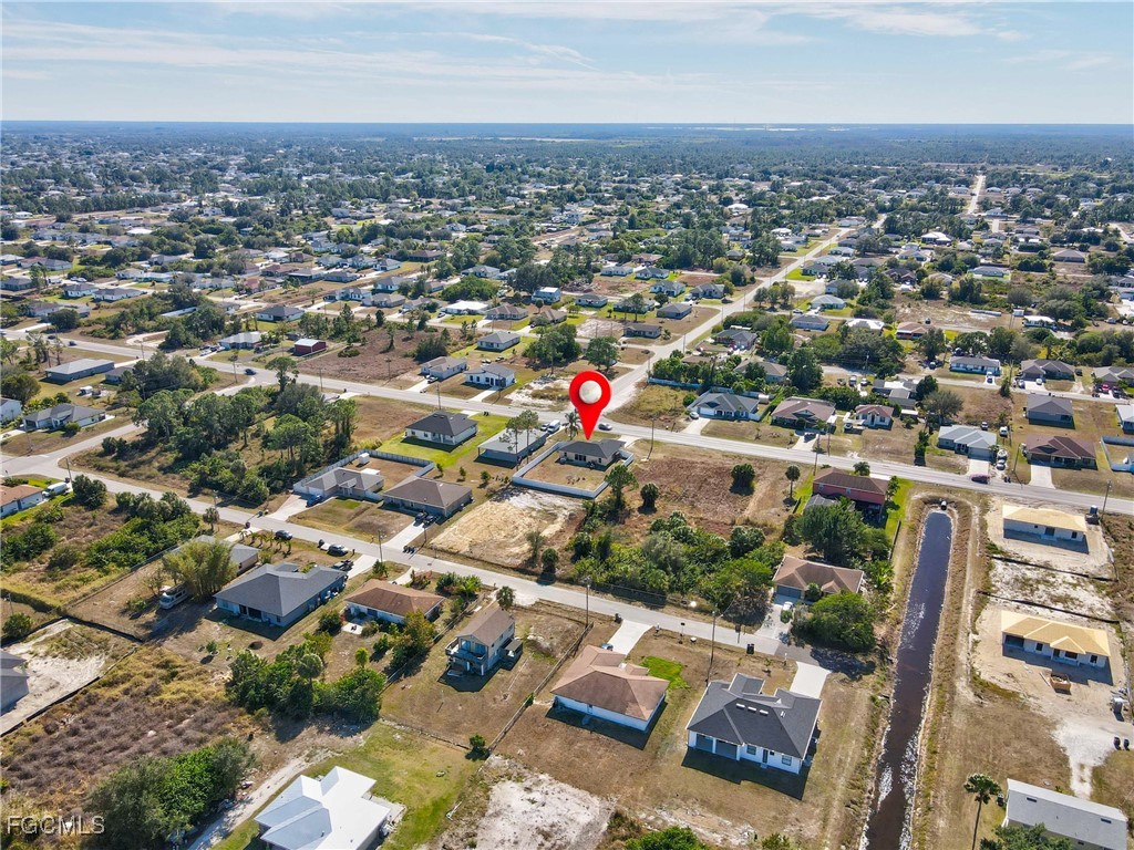 3910 23rd Street Southwest Lehigh Acres, FL 33976 - Photo 28 of 29 an aerial view of a city with lots of residential buildings