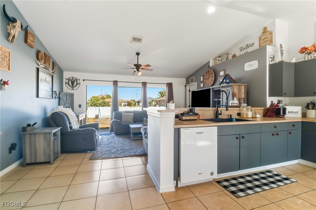 3910 23rd Street Southwest Lehigh Acres, FL 33976 - Photo 8 of 29 a kitchen with stainless steel appliances a stove top oven cabinets a sink and a window