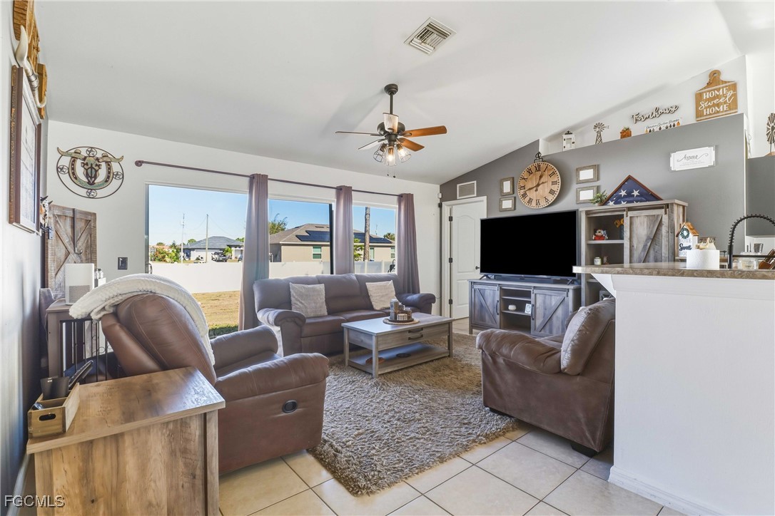 3910 23rd Street Southwest Lehigh Acres, FL 33976 - Photo 9 of 29 a living room with furniture and a flat screen tv