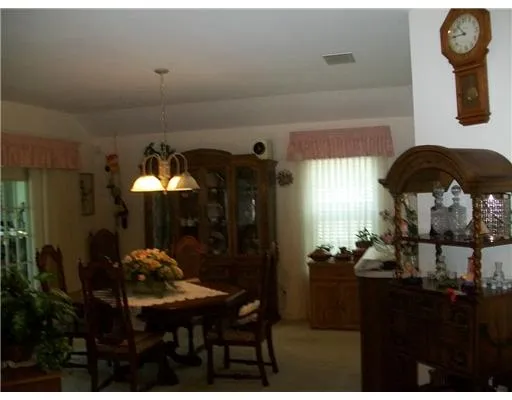 a living room with furniture and a mirror