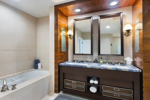a bathroom with a sink a vanity and a mirror