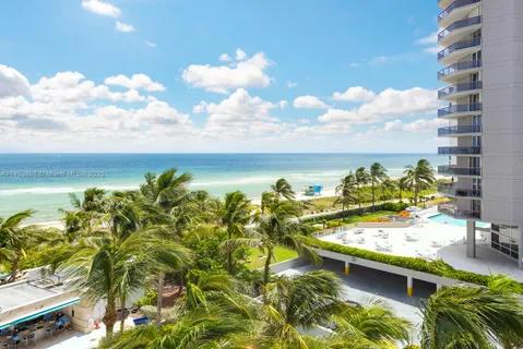 a view of a swimming pool with an outdoor seating