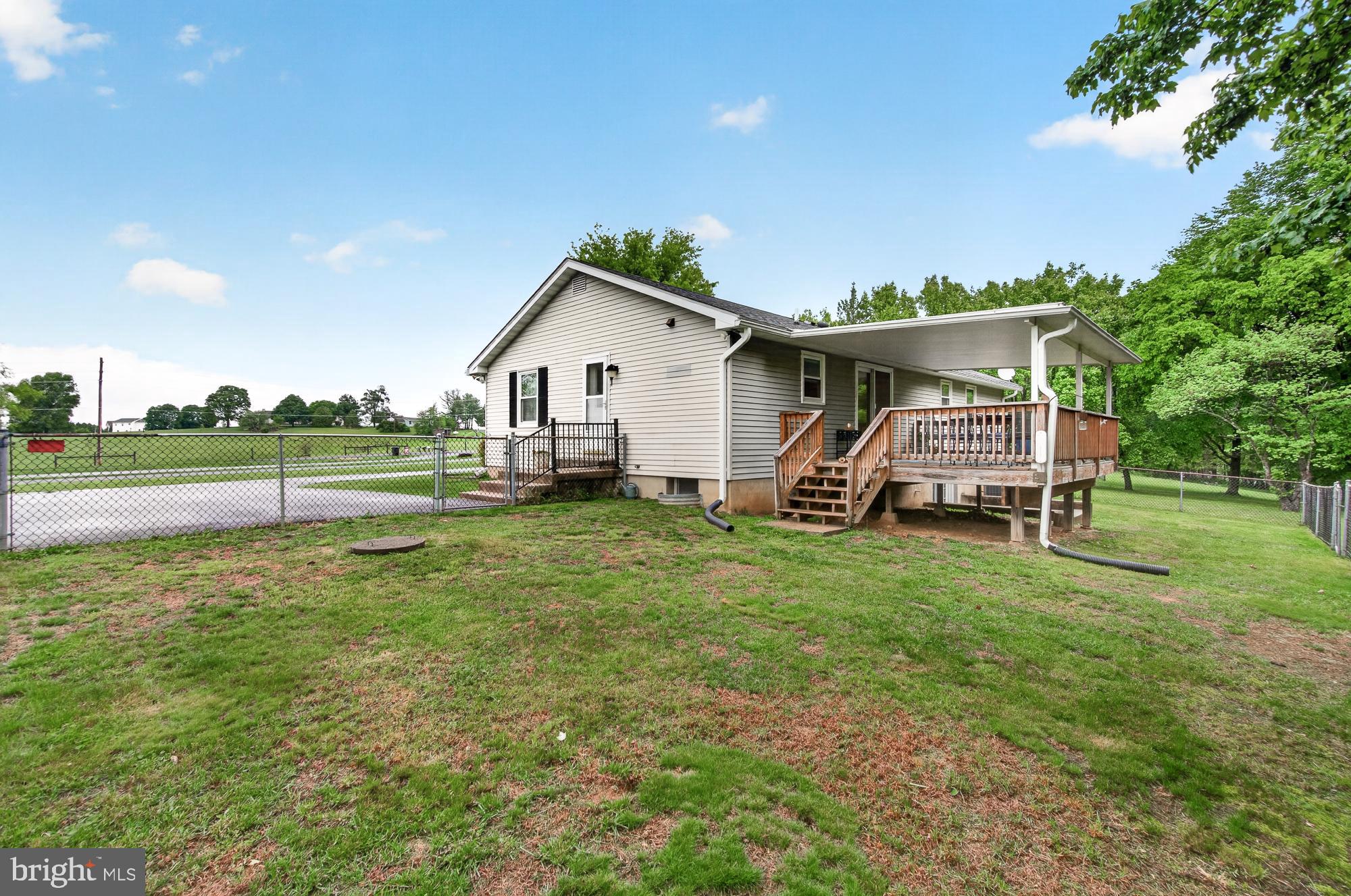 5601 Woodville Road Mount Airy, MD 21771 - Photo 46 of 54 a view of a house with a yard and sitting area