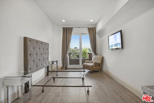 a bedroom with a bed and lamp with table