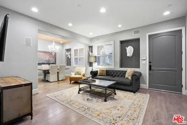 a living room with furniture and a chandelier
