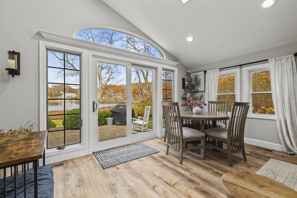 90 R Bartlett Road Plymouth, MA 02360 - Photo 19 of 35 a view of a dining room with furniture large windows and wooden floor