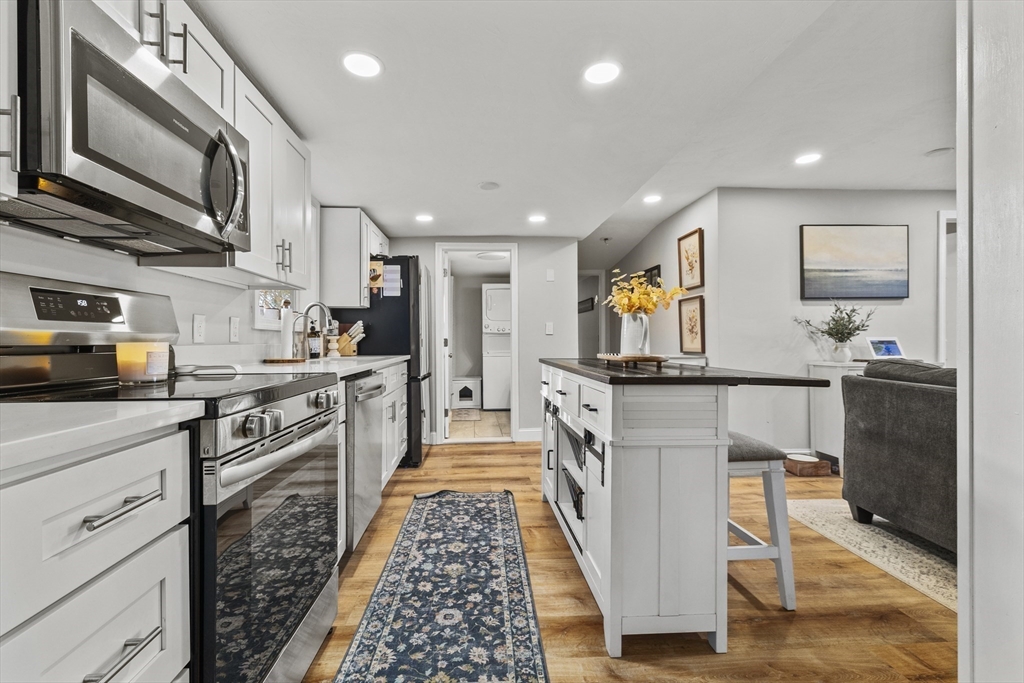 90 R Bartlett Road Plymouth, MA 02360 - Photo 9 of 35 a kitchen with stainless steel appliances granite countertop a stove a sink and a refrigerator