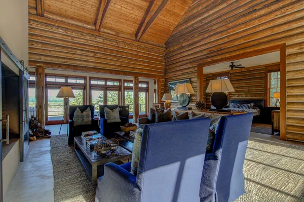 a dining room with furniture and wooden floor