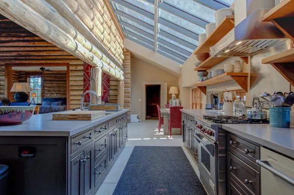 a bedroom with a bed and large windows