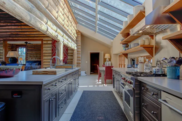 a bedroom with a bed and large windows