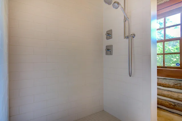 a view of a dining room with furniture large windows and wooden floor