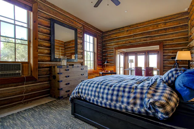 a bedroom with a bed and flat screen tv