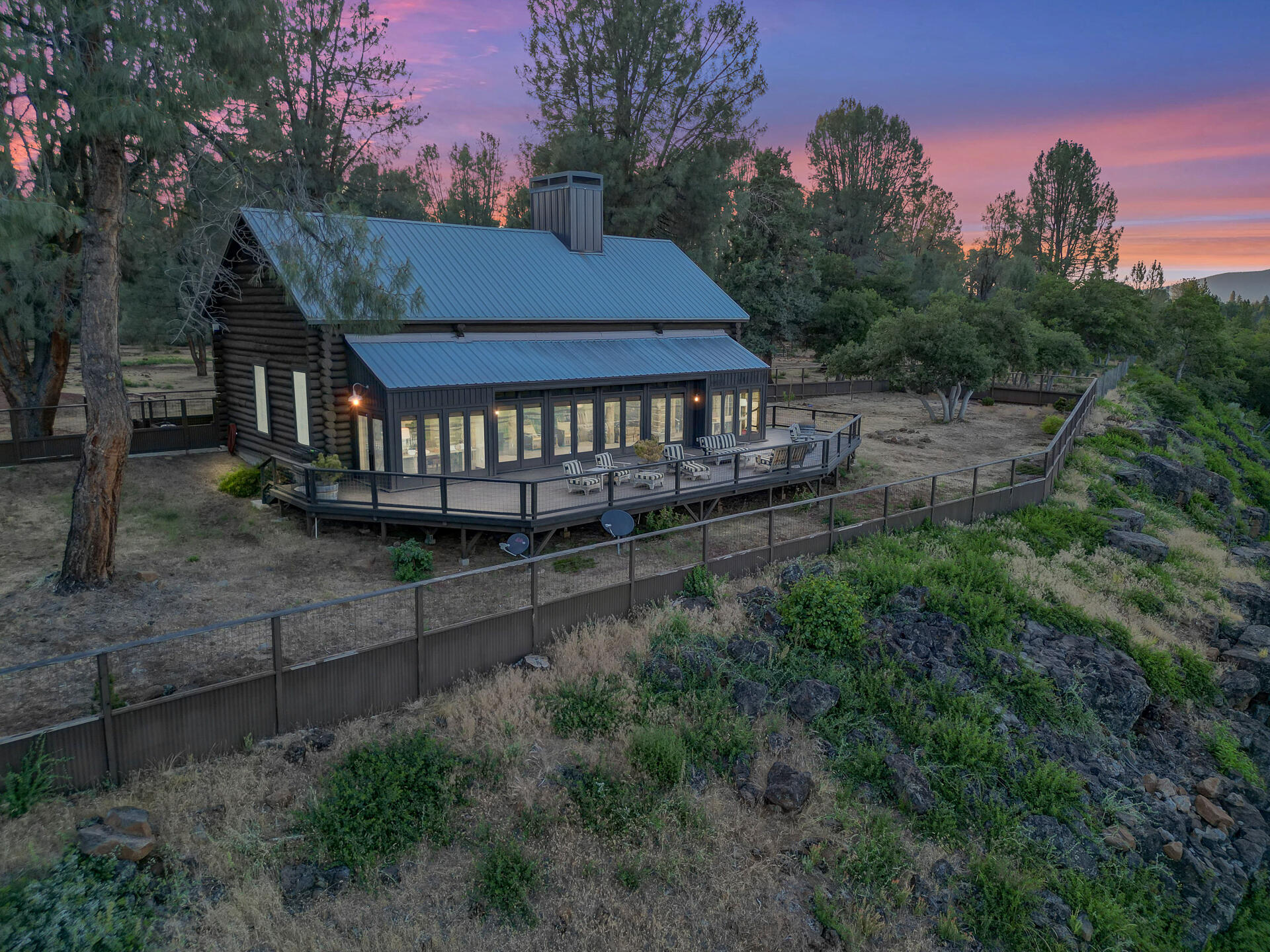 21151 Ridge Road Hat Creek, CA 96040 - Photo 4 of 68 a view of a wooden house with a small yard