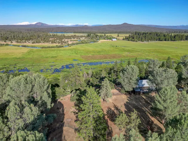 a view of a swimming pool with a yard and mountain view