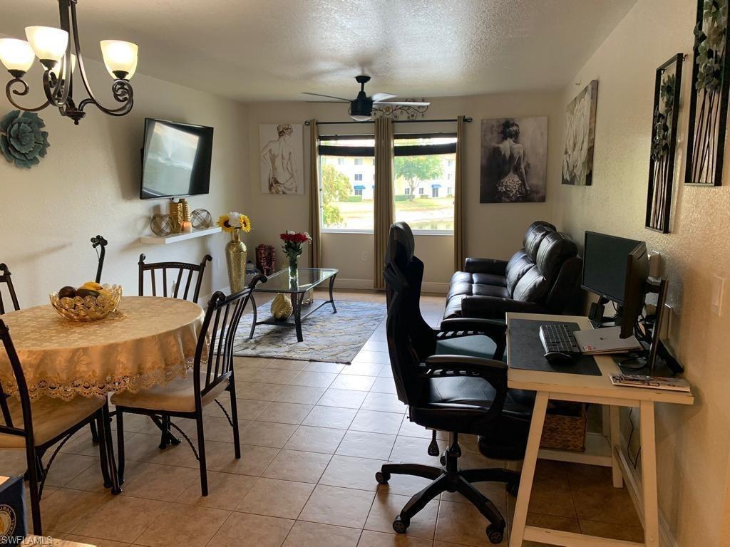 8224 Key Royal Circle, Unit 223 Naples, FL 34119 - Photo 2 of 17 a view of a dining room with furniture and a window