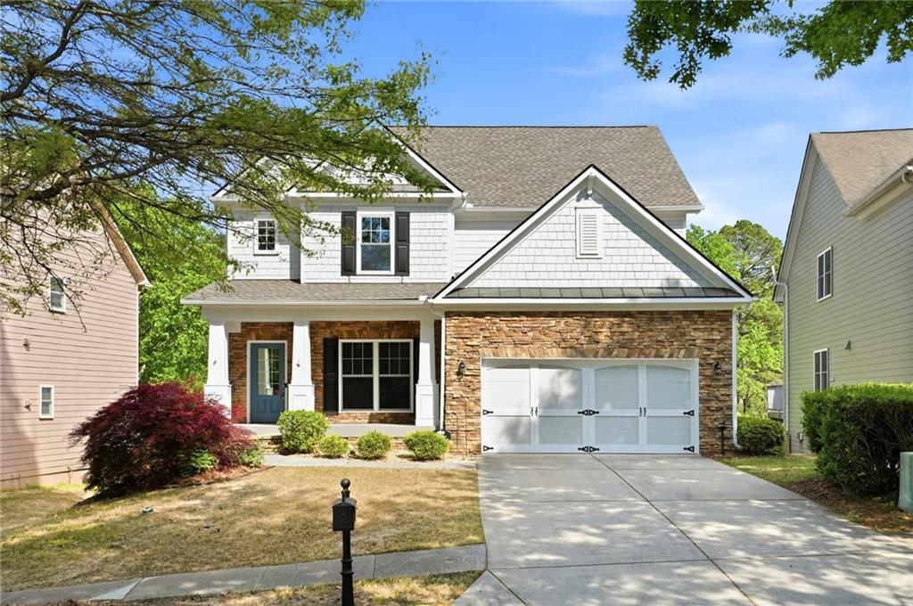 a front view of a house with yard and parking