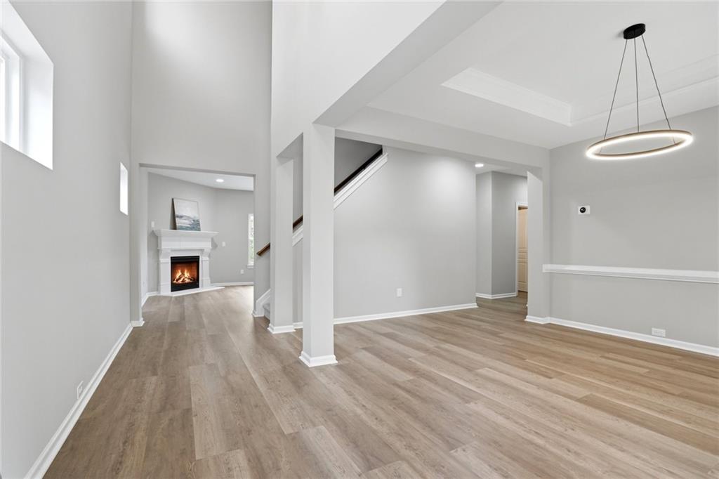7812 Keepsake Lane Flowery Branch, GA 30542 - Photo 2 of 78 a view of a livingroom with wooden floor and fireplace