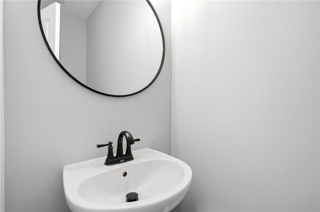 7812 Keepsake Lane Flowery Branch, GA 30542 - Photo 27 of 78 a bathroom with a sink and a mirror