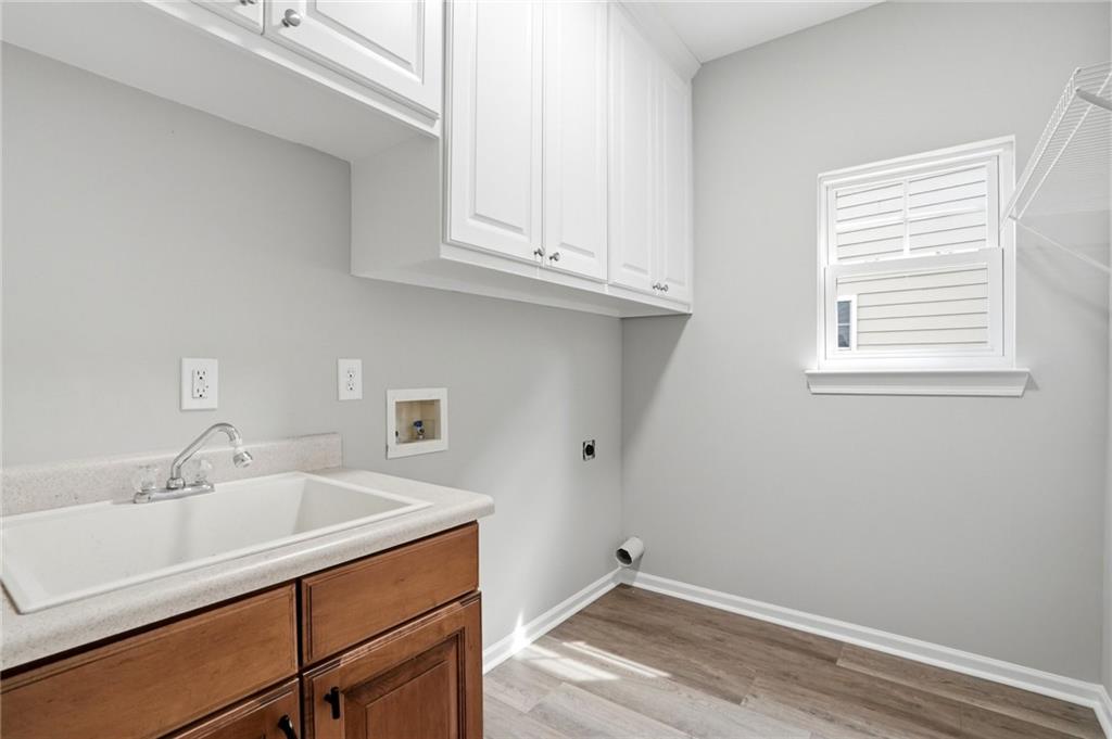7812 Keepsake Lane Flowery Branch, GA 30542 - Photo 28 of 78 a room with a sink cabinets and wooden floor