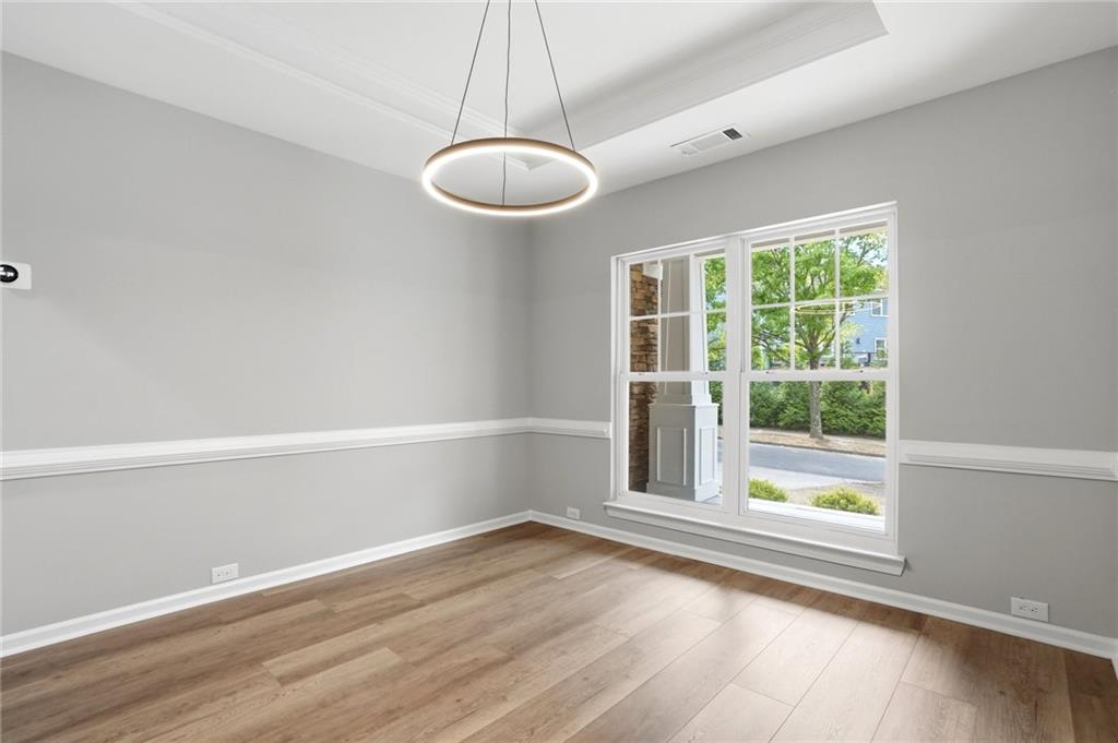 7812 Keepsake Lane Flowery Branch, GA 30542 - Photo 3 of 78 a view of an empty room with wooden floor and a window
