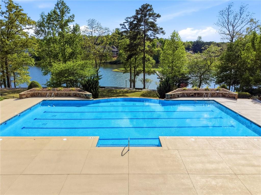 7812 Keepsake Lane Flowery Branch, GA 30542 - Photo 37 of 78 a view of a swimming pool with an outdoor space and seating area