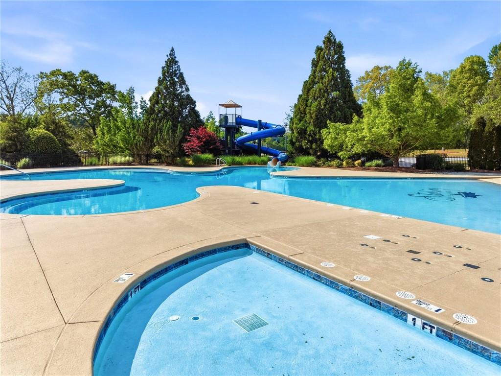7812 Keepsake Lane Flowery Branch, GA 30542 - Photo 39 of 78 a view of swimming pool and trees in the background