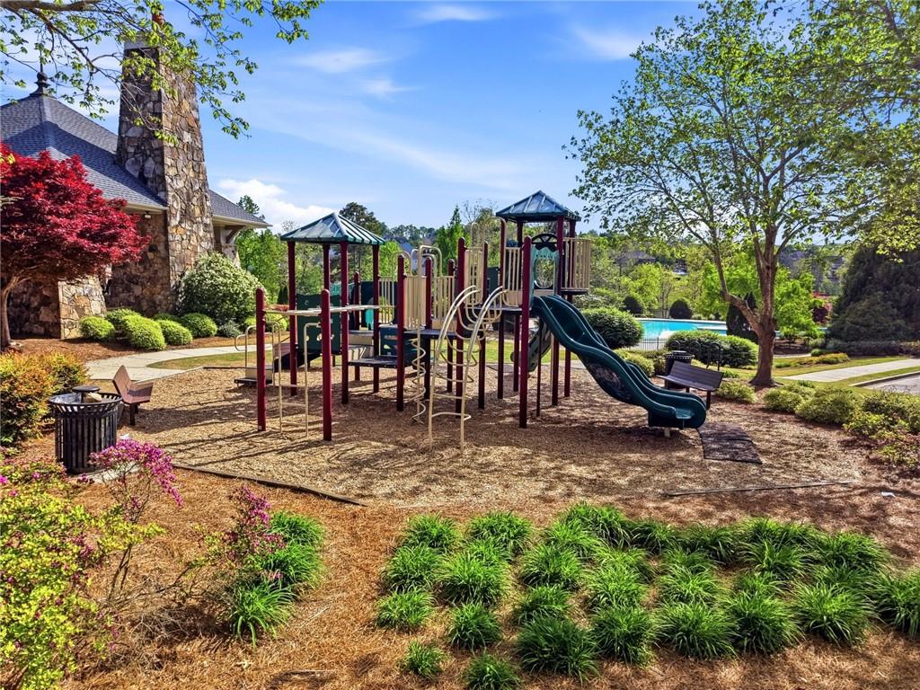 7812 Keepsake Lane Flowery Branch, GA 30542 - Photo 43 of 78 a view of a park with swings and slides