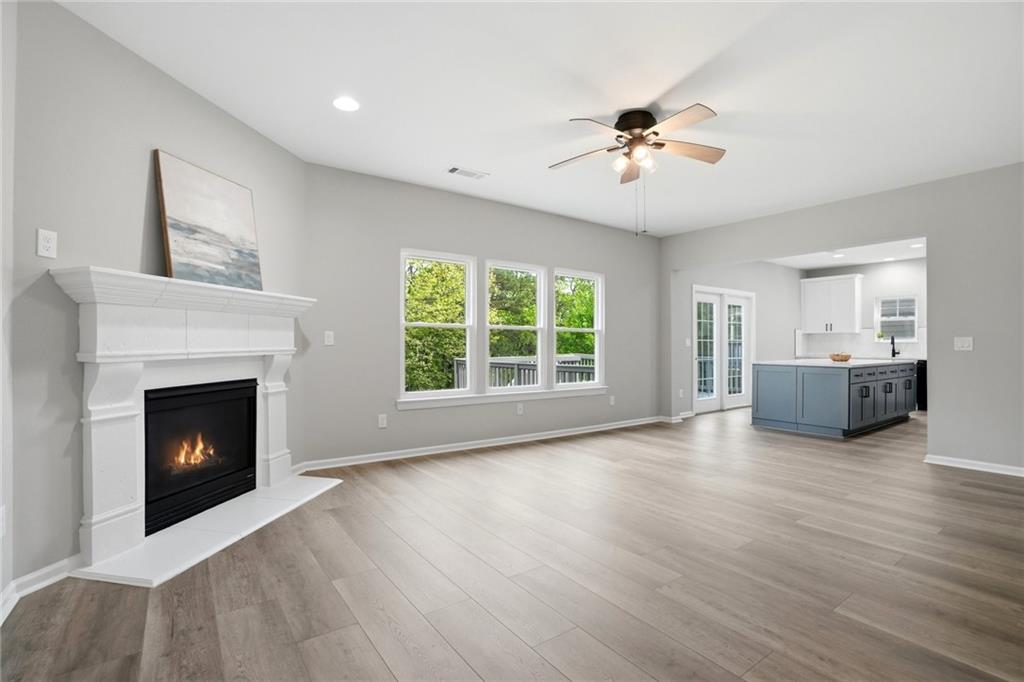 7812 Keepsake Lane Flowery Branch, GA 30542 - Photo 5 of 78 a view of an empty room with a fireplace and a window