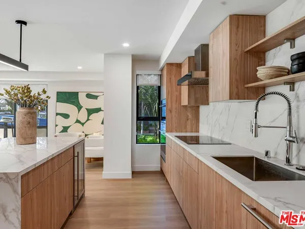 a kitchen with stainless steel appliances granite countertop a sink and a stove