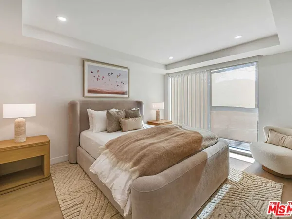 a spacious bedroom with a bed and a couch