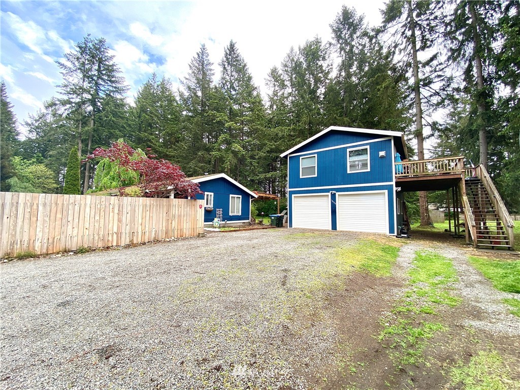 18436 Loganberry Street Southwest Rochester, WA 98579 - Photo 1 of 29 a front view of a house with a yard and garage