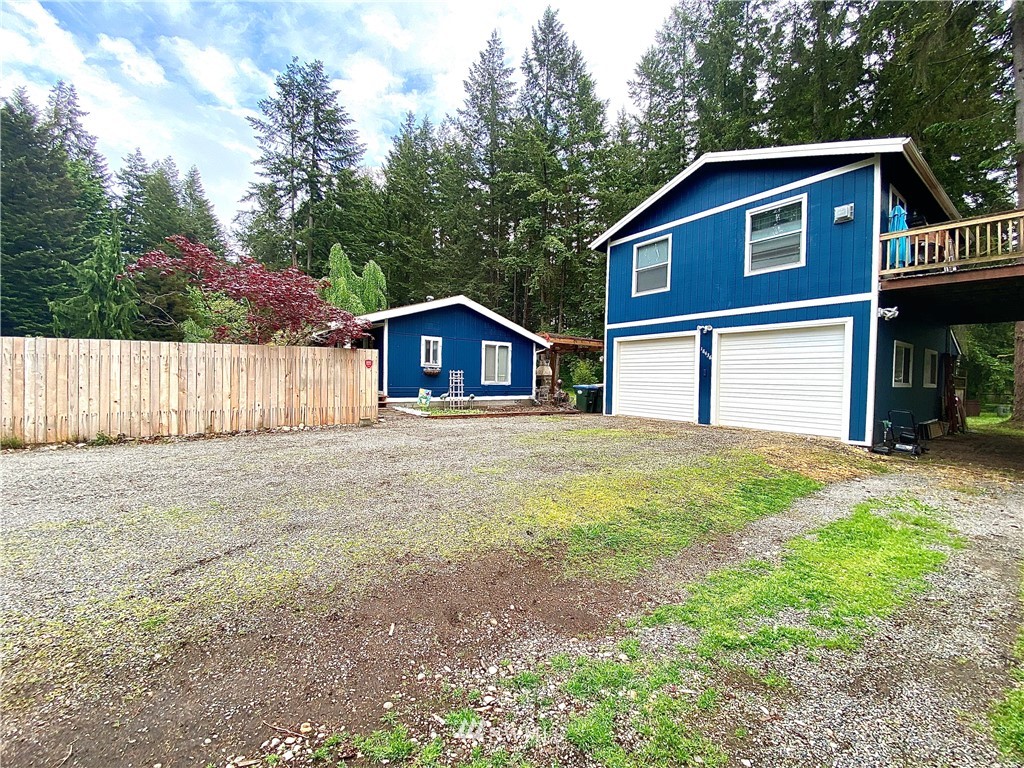 18436 Loganberry Street Southwest Rochester, WA 98579 - Photo 3 of 29 a front view of a house with a yard and garage